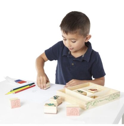 Boy playing with Dinosaur Stamp Set